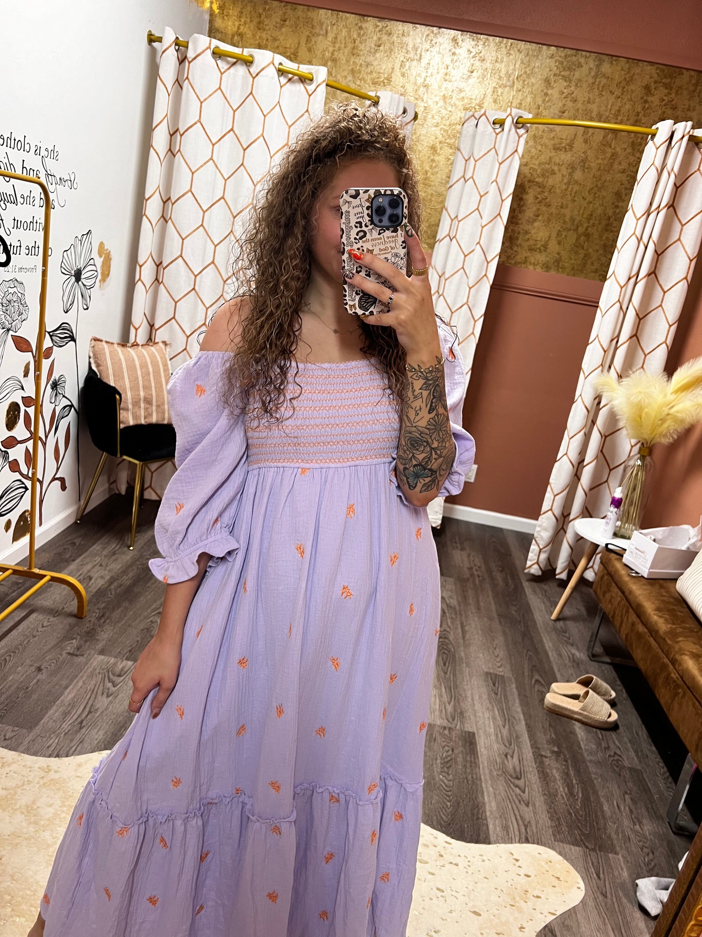 people and orange embroidered dress