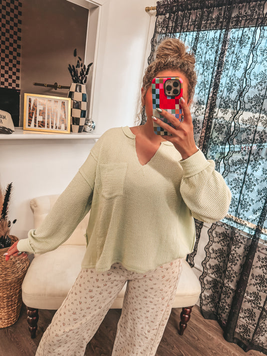 light green raw split neck long sleeve top
